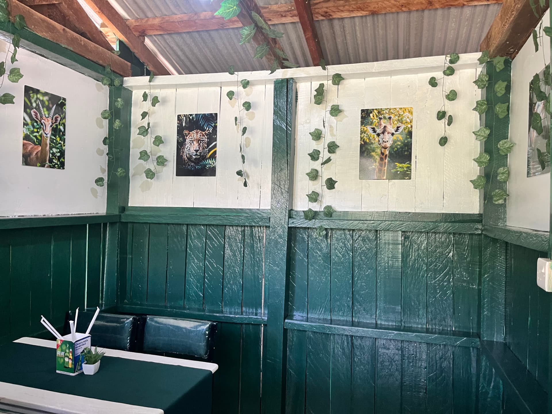 Booth with wildlife prints and hanging greenery